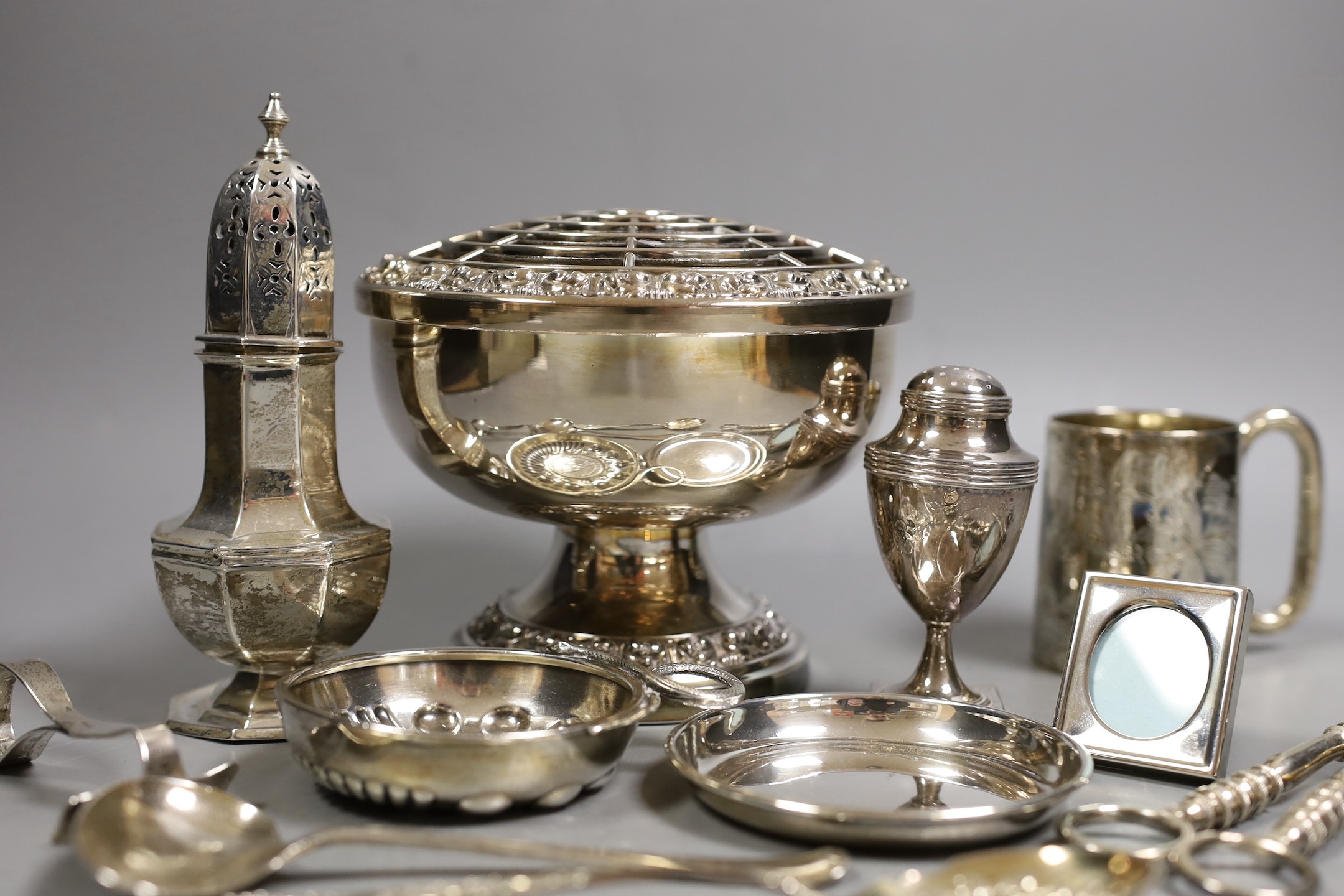 A George III silver vase shaped pepperette, Richard Evans? London, 1788, 88mm, a Victorian silver christening mug, a later silver sugar caster, a French white metal taste vin and other sundry silver and plated items.